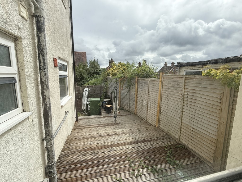 Lot: 115 - FLAT IN NEED OF IMPROVEMENT - Rear Patio in Ground Floor Flat in Need of Improvement